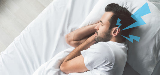 Image of man trying to sleep with tinnitus, which is what the SomniBand Sleep Headphones help fix.